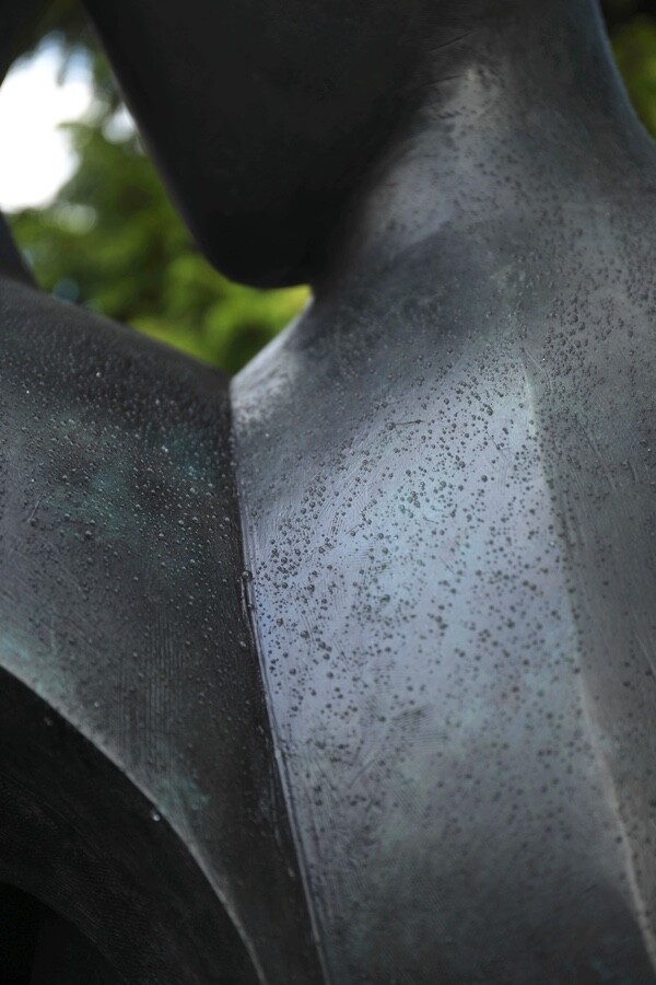 Detail of a large hospital commissioned bronze sculpture of two supportive figures