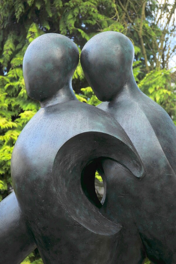 Large hospital commissioned bronze sculpture of two supportive figures