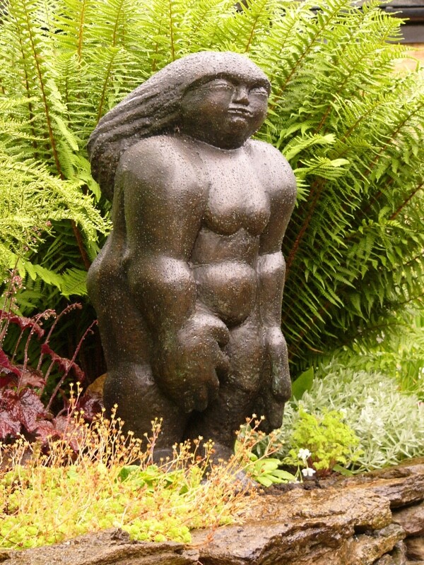 Bronze sculpture of a compact figure based on a stone carving