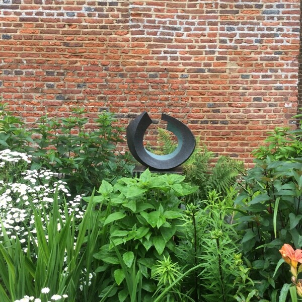 Abstract circular garden bronze sculpture coloured green and black