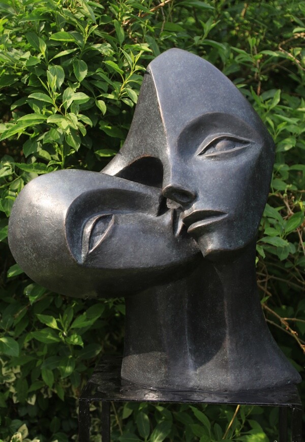 contemporary garden bronze sculpture of a double head loosely based on Picasso