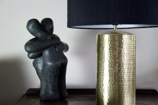 Modern affectionate bronze sculpture of a hug for a wedding anniversary