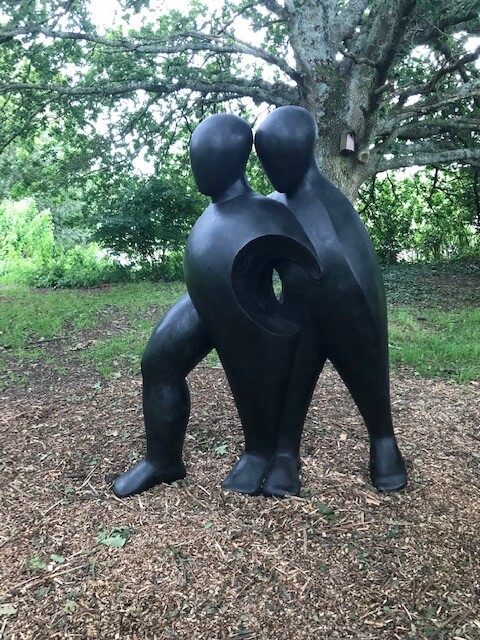 The bronze resin life-size Sculpture Walking Forwards describes one person supporting another