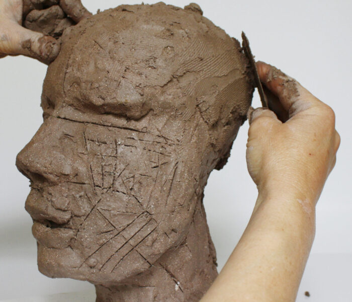 0002_28d) smoothing added clay round the cranium towards the front view