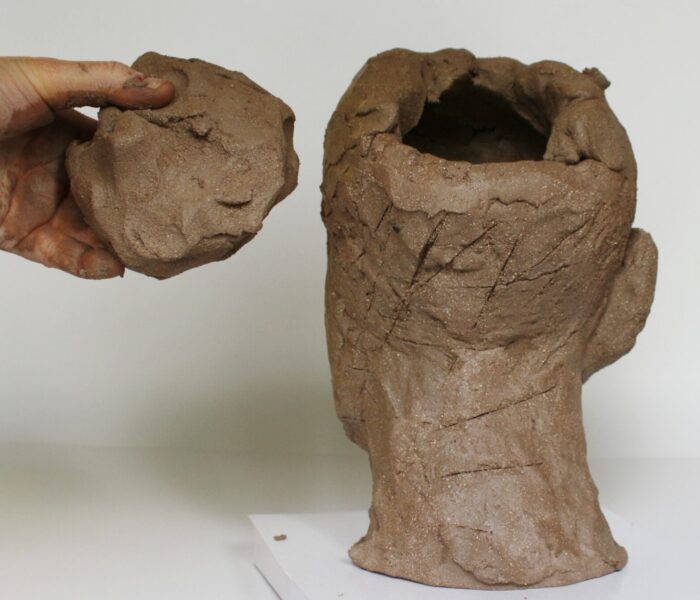 0072_25a) closing the top hole with a plug of clay