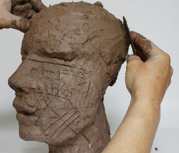 0092_28d) smoothing added clay round the cranium towards the front view