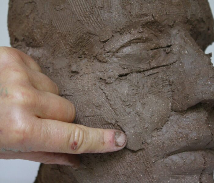 0163_58b) blending in extra clay to build up cheek bordering philtrum area