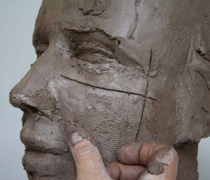 0166_adding clay with finger mouth area